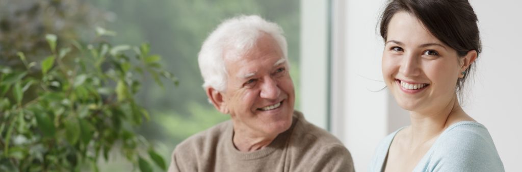 Smiling grandfather and caring granddaughter - panorama